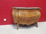 a small wooden chest of drawers with a marble top