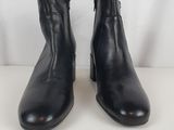 a pair of black leather boots on a white background