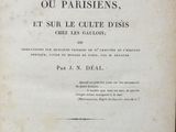an old book with writing on it sitting on a table