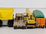 a lot of toy trucks that are lined up on a table