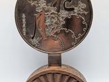 an image of a bronze plate with a horse and rider on it