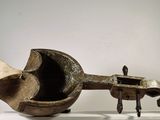a sculpture of a pipe on a stand on a white surface