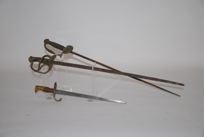 two different types of swords on display on a white surface