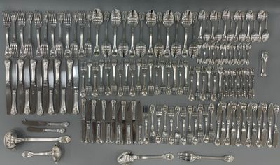 a lot of silver spoons and forks on the table
