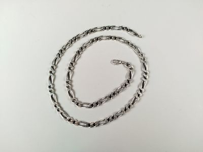 a close up of a silver chain on a white surface