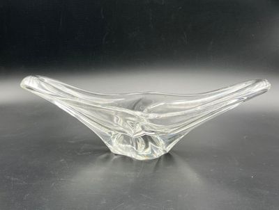 clear glass bowl sitting on top of a table with a black background