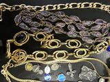 many different types of necklaces and bracelets on the table