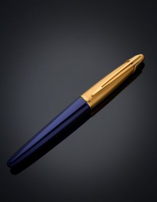 a gold and blue fountain pen on a black background