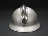 a silver helmet that is sitting on a table