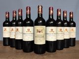 six bottles of red wine are lined up on a table