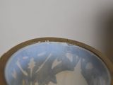 a blue and white bowl with a cat in it