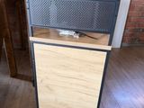 a microwave oven sitting on top of a wooden cabinet