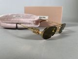 the sunglasses are on the table next to a pink case