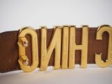 a close up of a belt with the word ching on it