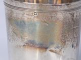 a silver cup that is sitting on a table