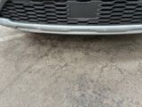 a close up of a car ' s front grill and bumper