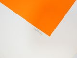 someone is writing on a piece of orange paper with a pen