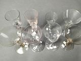 several empty wine glasses are lined up on a table