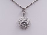a close up of a diamond pendant on a chain