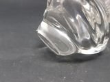 a clear glass vase on a table with a black background