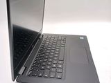 a laptop that is open on a white surface