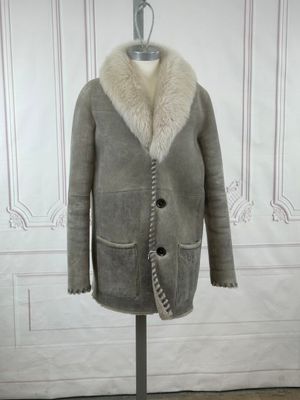 an image of a coat with a fur collar on a mannequin stand