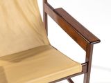 a chair with a tan fabric on it and a wooden frame