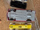 several toy trains are lined up on a clear plastic case