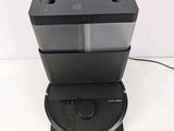 a close up of a black and silver coffee maker on a white surface