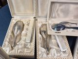 several silverware items are in a case on a blue table