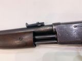 a close up of a gun on a table with a white background