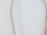 a white chair that has a handle on it