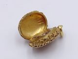 a small gold locke on a white surface