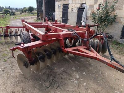 an image of a tractor with a plow attached to it ' s back