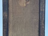 an old picture frame sitting on top of a wooden table