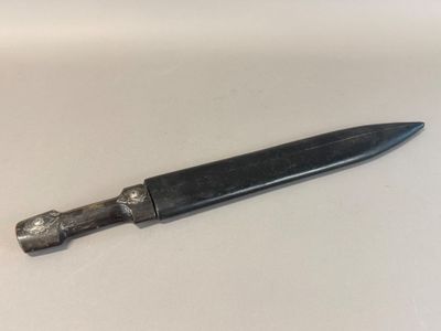 a knife that is laying on a white surface