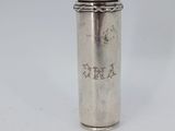 an old silver cup with a straw in it on a white surface