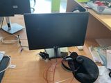 a desk with two monitors and a laptop on it