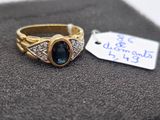 a gold ring with a blue stone on it and a price tag
