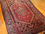 a rug on the floor in a room with wooden floors
