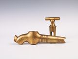 a brass faucet that is sitting on a white surface
