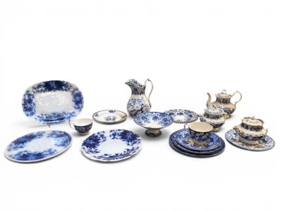 several pieces of blue and white china on a white surface