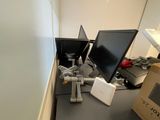 a desk with two computer monitors and a box on it