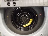 a yellow sticker on the tire of a washing machine