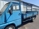 a blue truck that is parked in front of a building