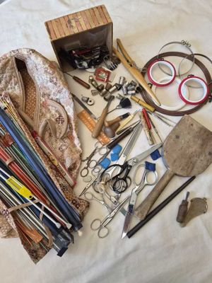 many different types of crafting tools on a bed