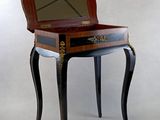 a small wooden table with a mirror on top of it