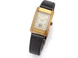 a gold plated wrist watch with a black leather band