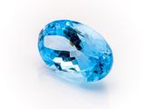 a close up of a blue topazte stone on a white surface