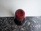 a close up of a red wine bottle on a table